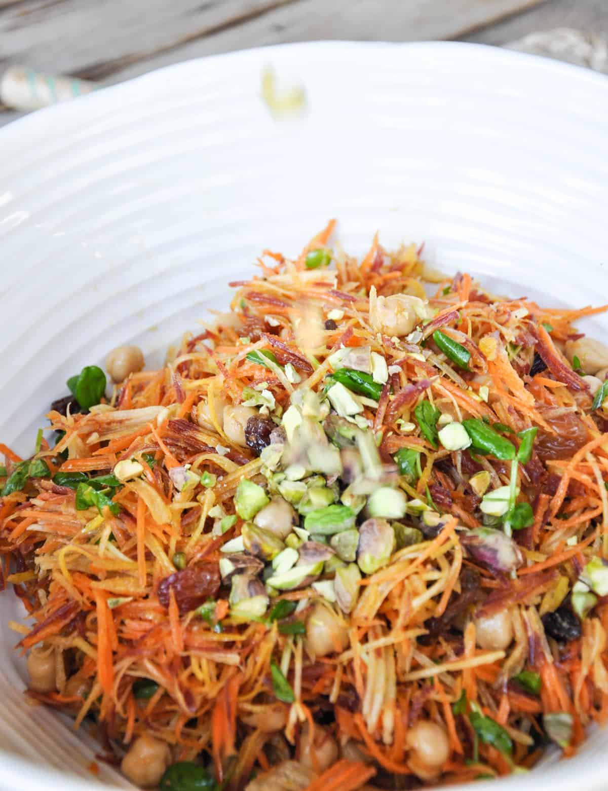 Sunshine Salad using Tri-Color Carrots with garbanzo beans, crimson raisins, pea shoots, feta cheese and pistachios. Holy yum!