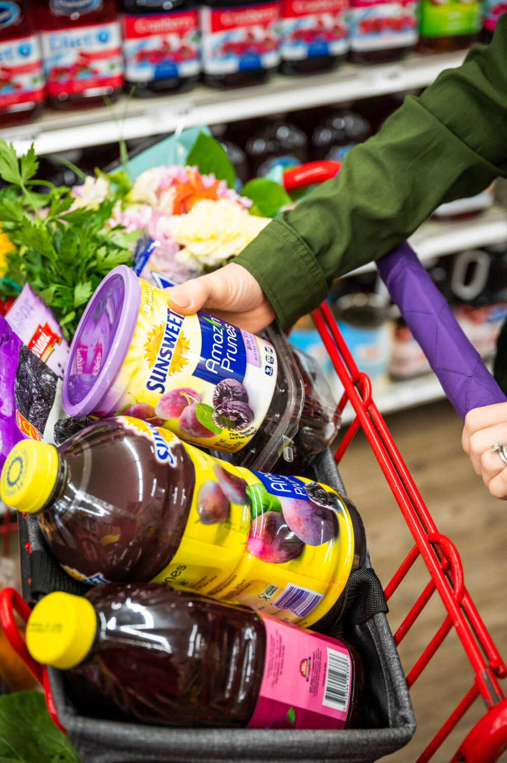 grocery cart in grocery store filled with prune products