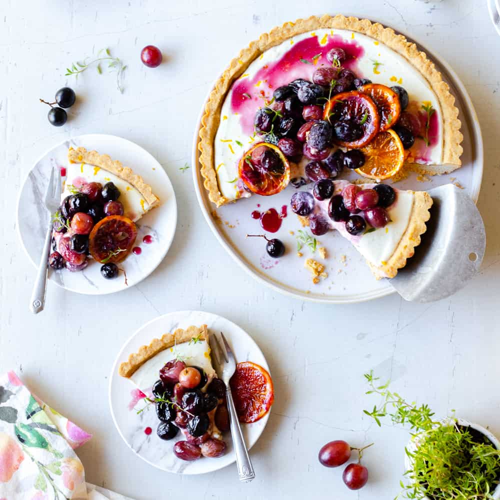 A Roasted Grape Goat Cheese Tart with two slices removed.