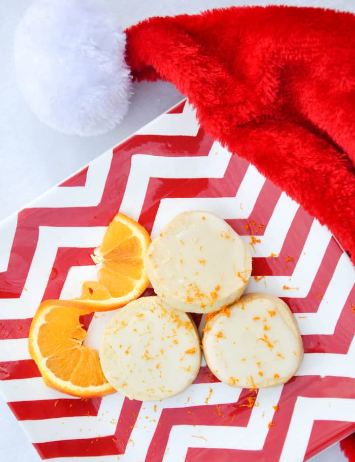 Citrus Shortbread Cookies with Orange Twist Laying Next to Them