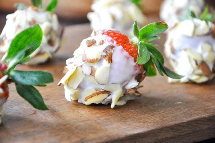 White chocolate crusted strawberries with almond slices
