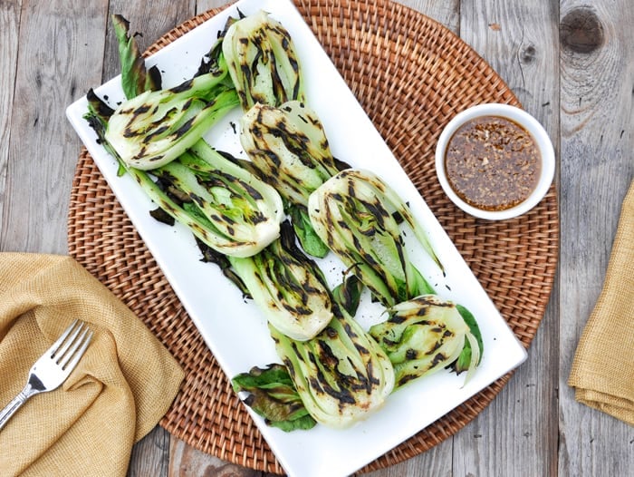 Grilled Baby Bok Choy with Garlic Sesame Dressing served on a platter 
