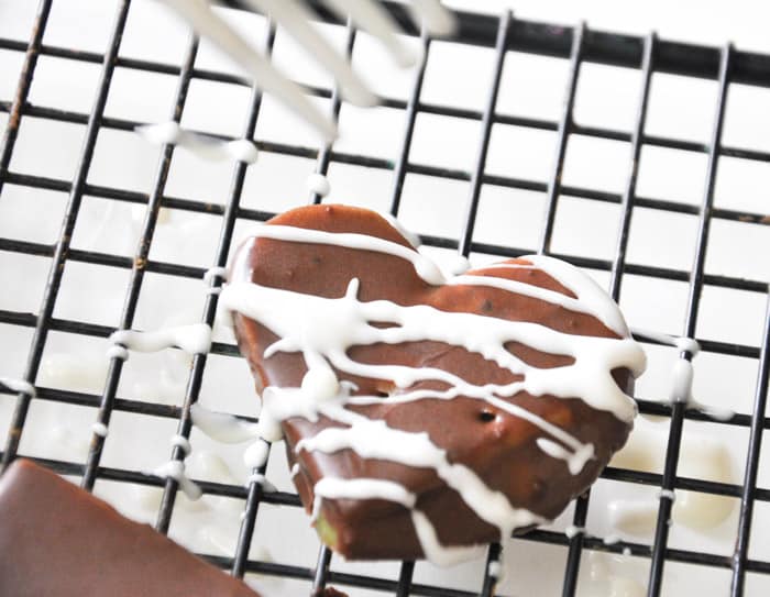 Drizzle the white chocolate over the chocolate covered kiwis 