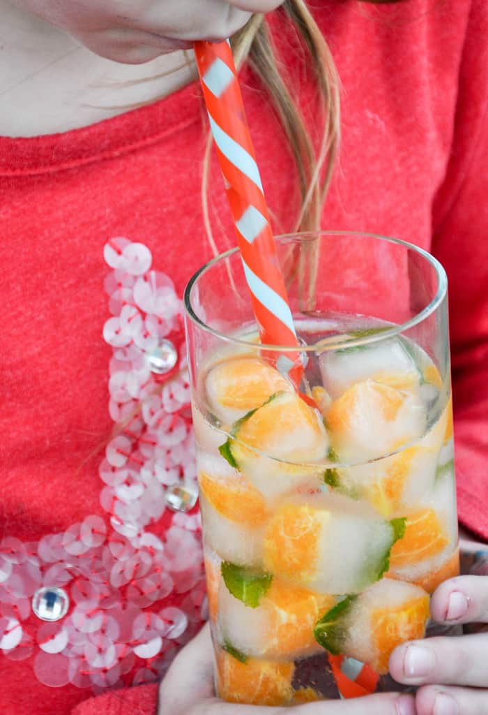 Child drinking from glass with Citrus Mint Ice