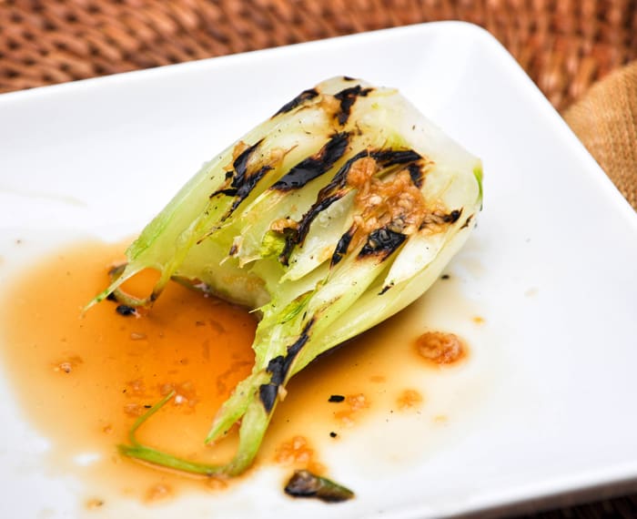 Grilled Baby Bok Choy with Garlic Sesame Dressing with a bite taken 