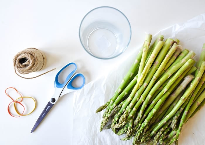 Cover a cylinder vase with fresh asparagus and fill with spring flowers!