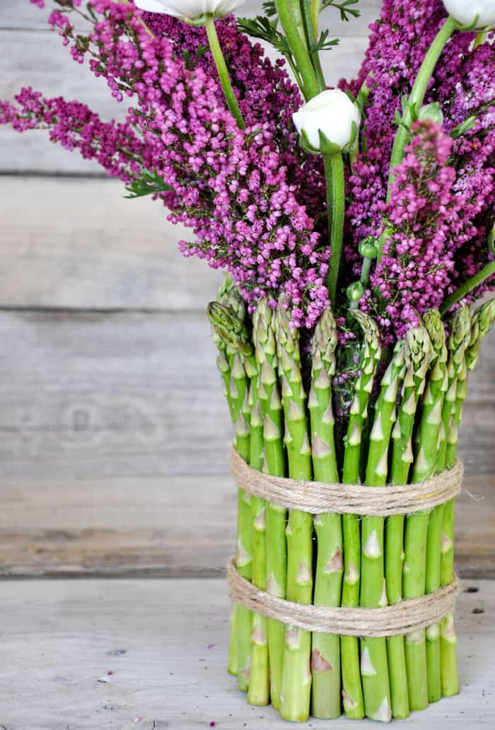 Cover a cylinder vase with fresh asparagus and fill with spring flowers!