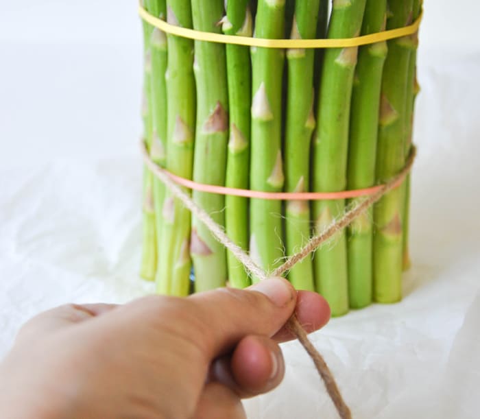 Cover a cylinder vase with fresh asparagus and fill with spring flowers!