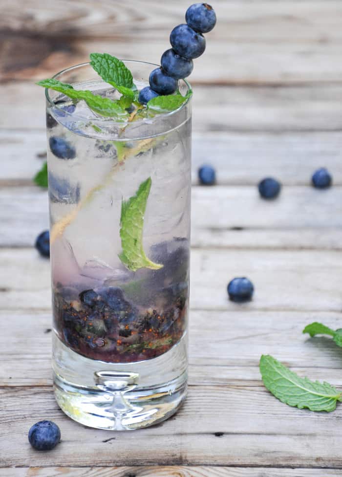 Blueberry Mojito with a Skewer full of blueberries 