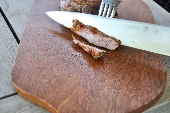 Slicing cooked lamb shoulder chop