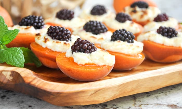 stuffed apricots with blackberries and cream cheese on a platter