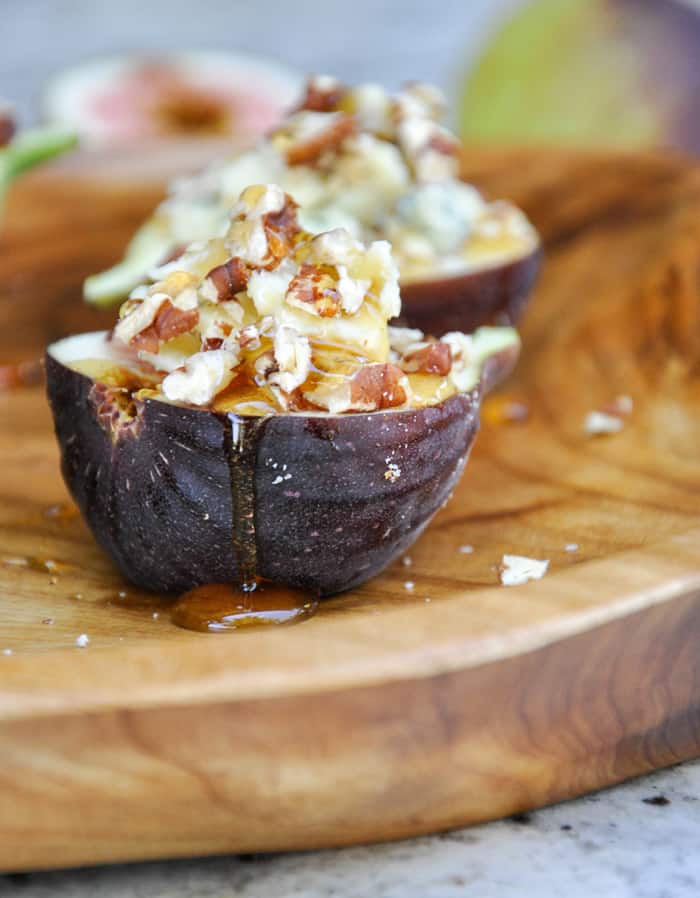 Close-Up of Fresh figs topped with Blue Cheese, Pecans and Honey