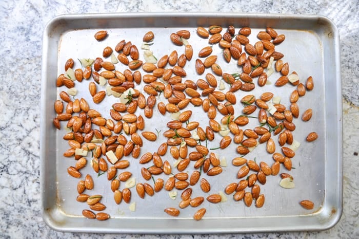 Seasoned almonds on a baking sheet