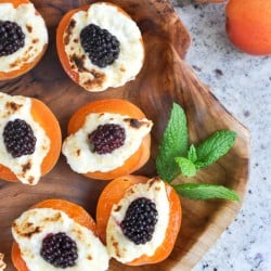 stuffed apricots with blackberries and cream cheese on a platter