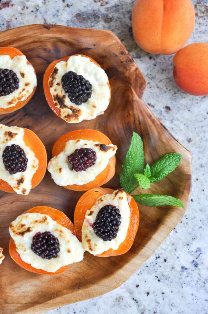 stuffed apricots with blackberries and cream cheese on a platter