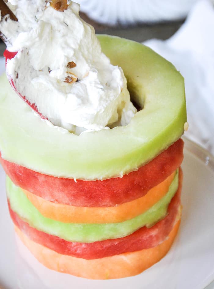 Fill staked melon rings with whipped cream filling