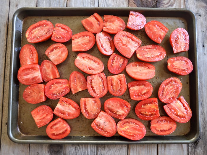 Halved Roma Tomatoes on baking sheet