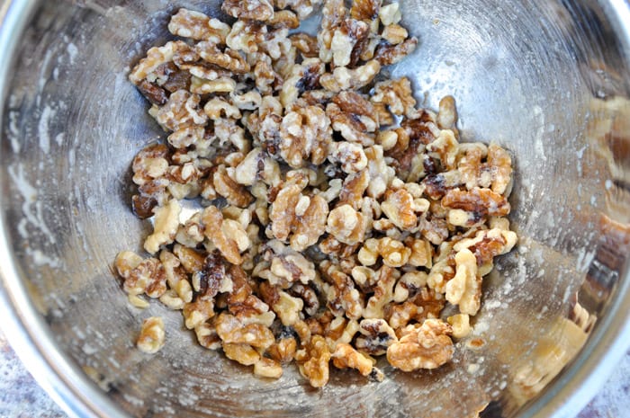 Toss walnuts in egg white 