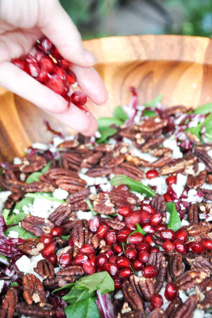 Pomegranates being added to top the salad