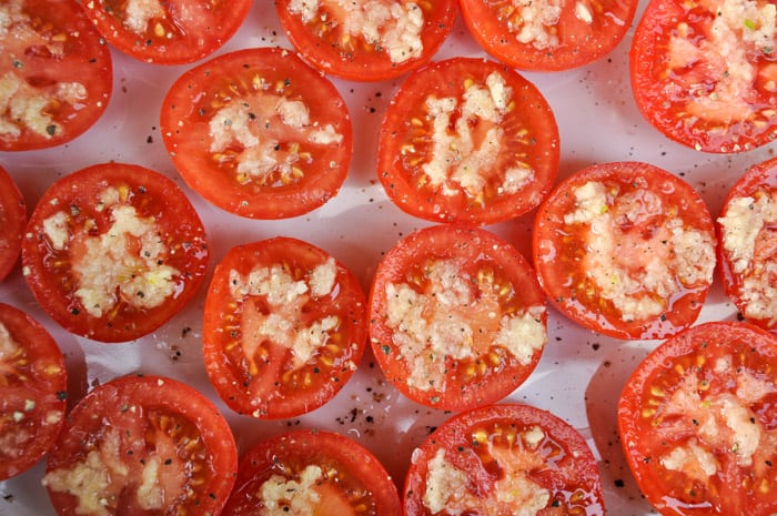 Halved Tomatoes with Garlic and Pepper on top