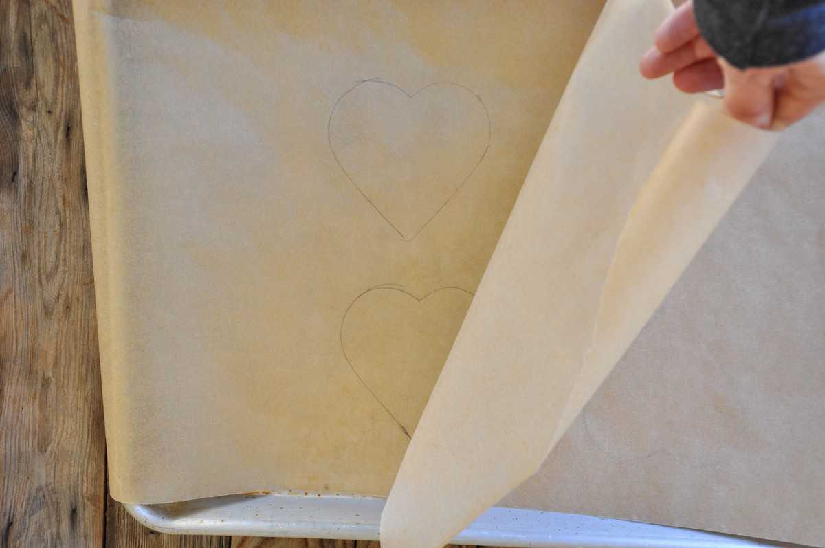 Hearts traced onto paper over baking sheet