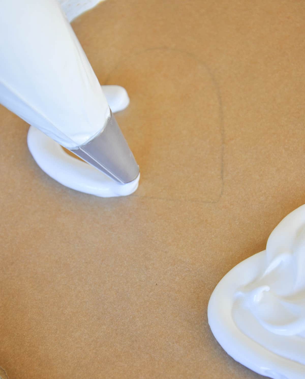 Piping the meringue onto the traced hearts