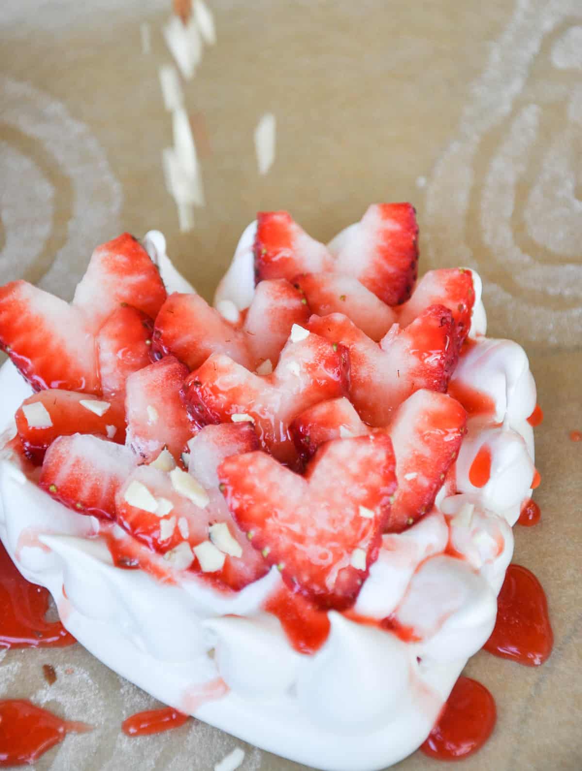 Sprinkle almonds over Strawberry Pavlova Hearts