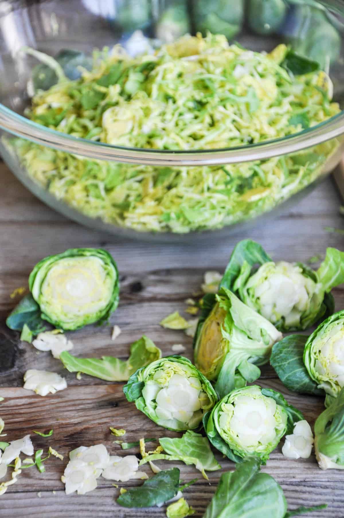 Halved Brussels Sprouts and shredded brussels sprouts in a bowl