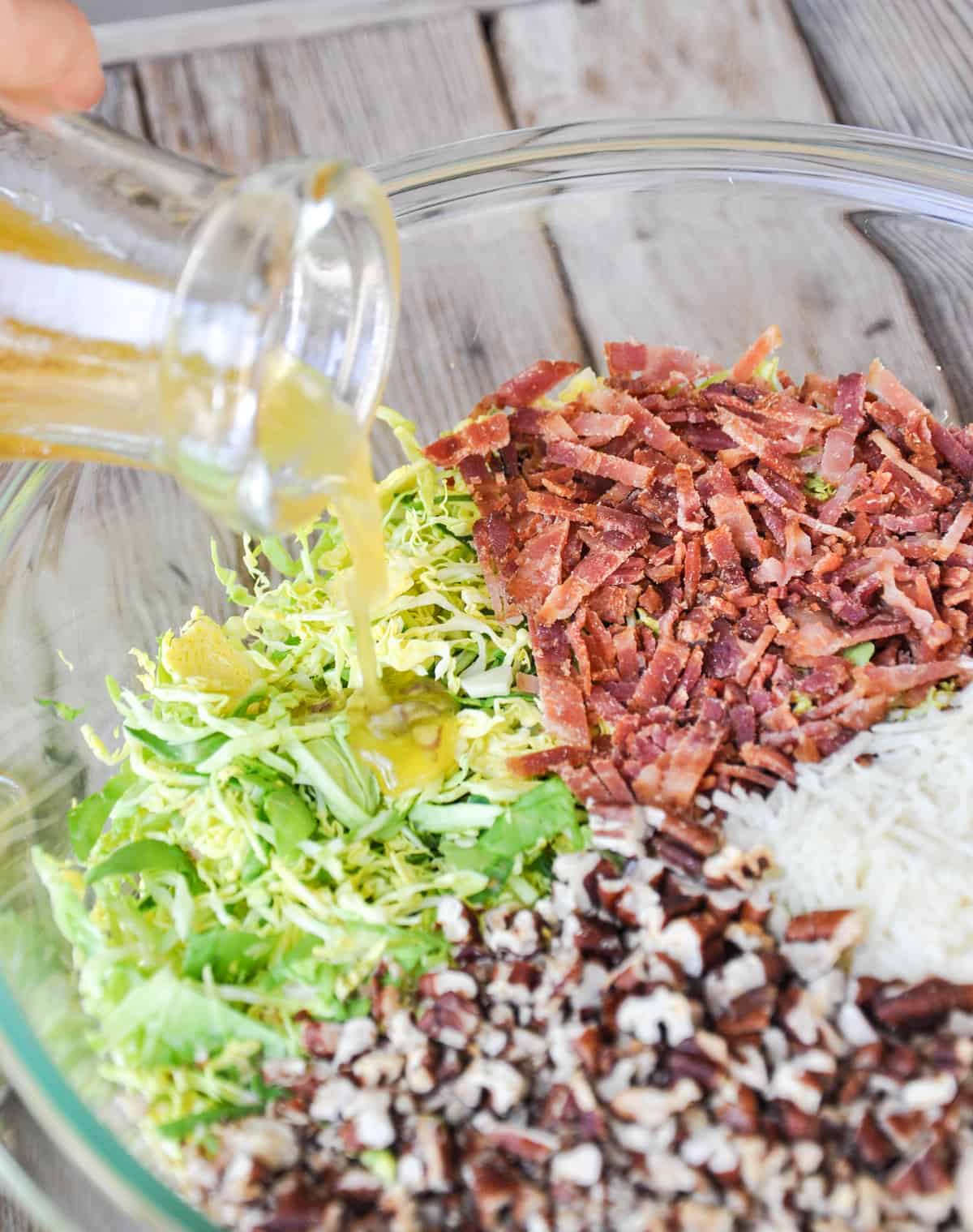  Maple Orange Dressing being poured over ingredients 