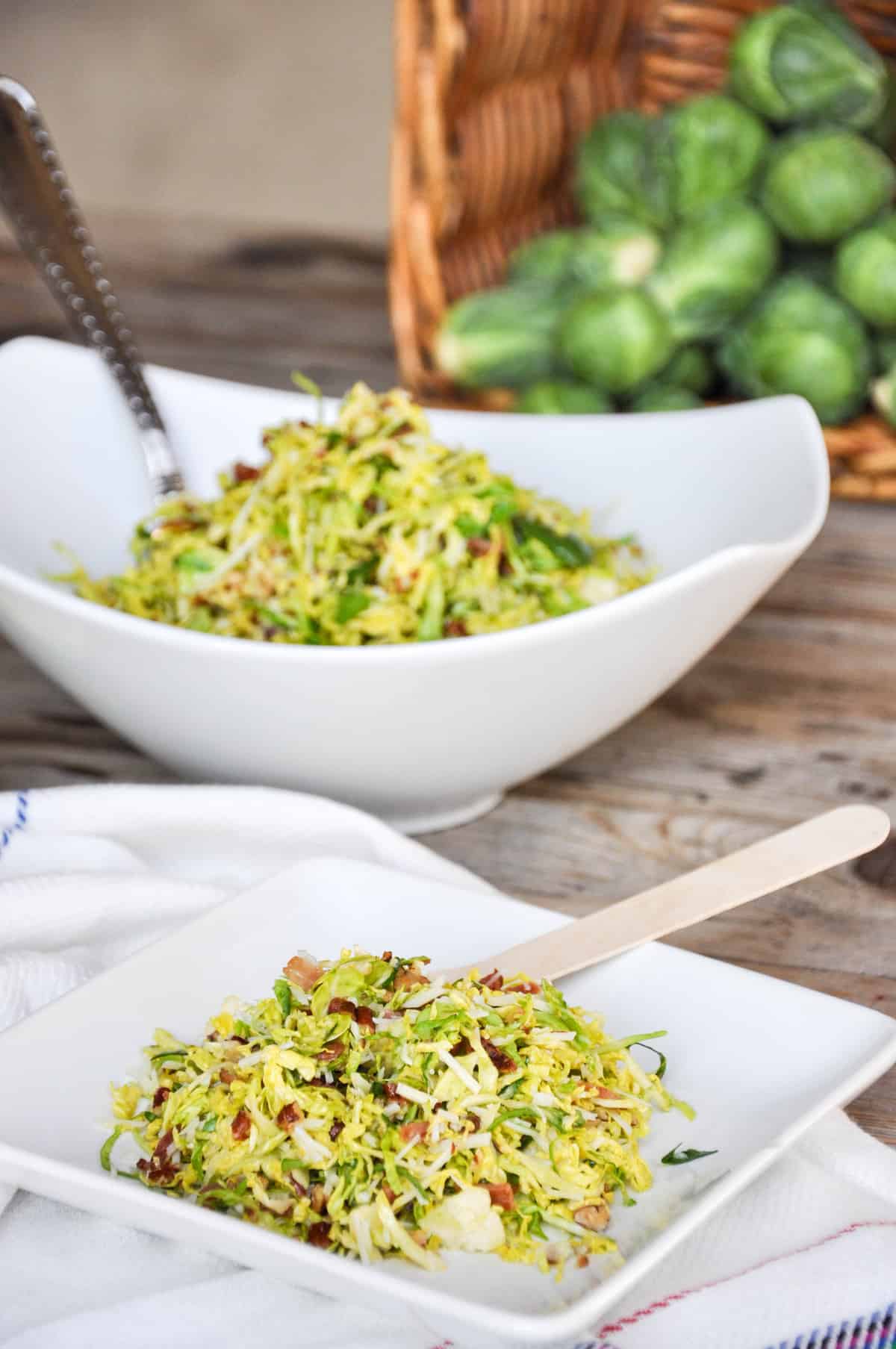 Bacon Pecan Brussel Sprout Salad with Maple Orange Dressing in a serving bowl and on a plate