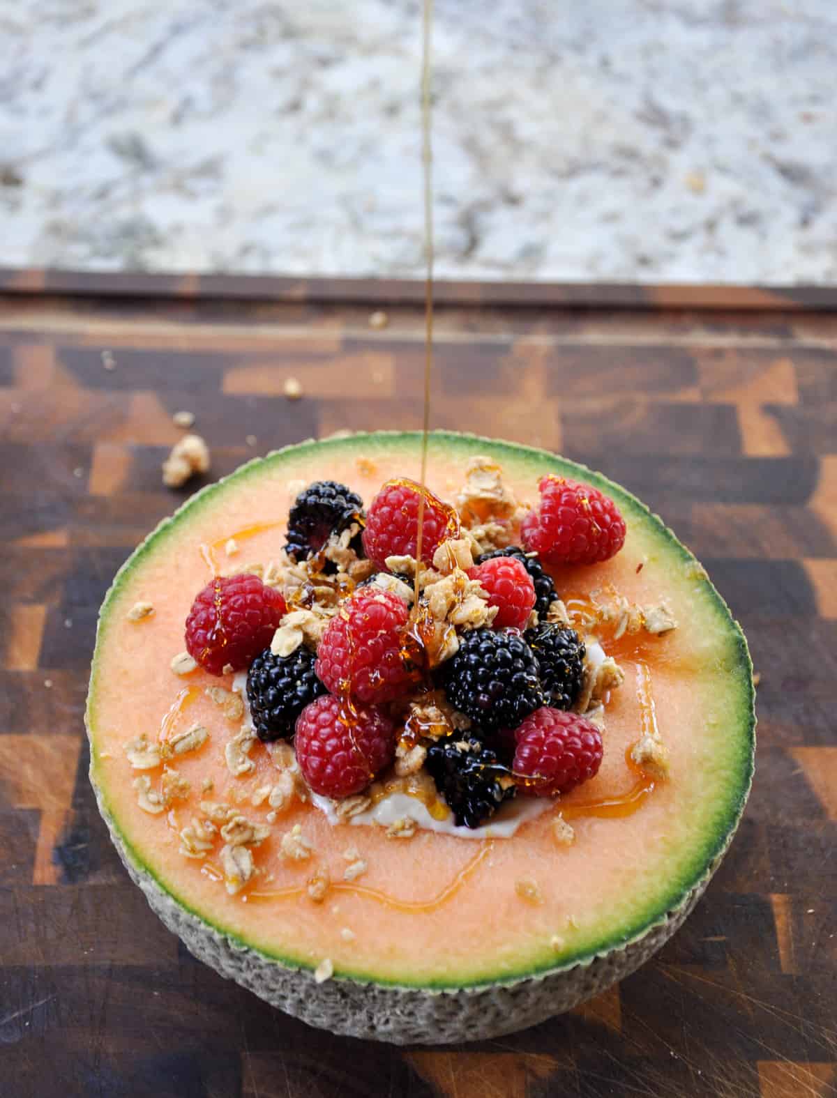 Cantaloupe Breakfast Bowls. Perfect for dessert too! Load the center with greek yogurt and top with fresh berries and granola. YUM!