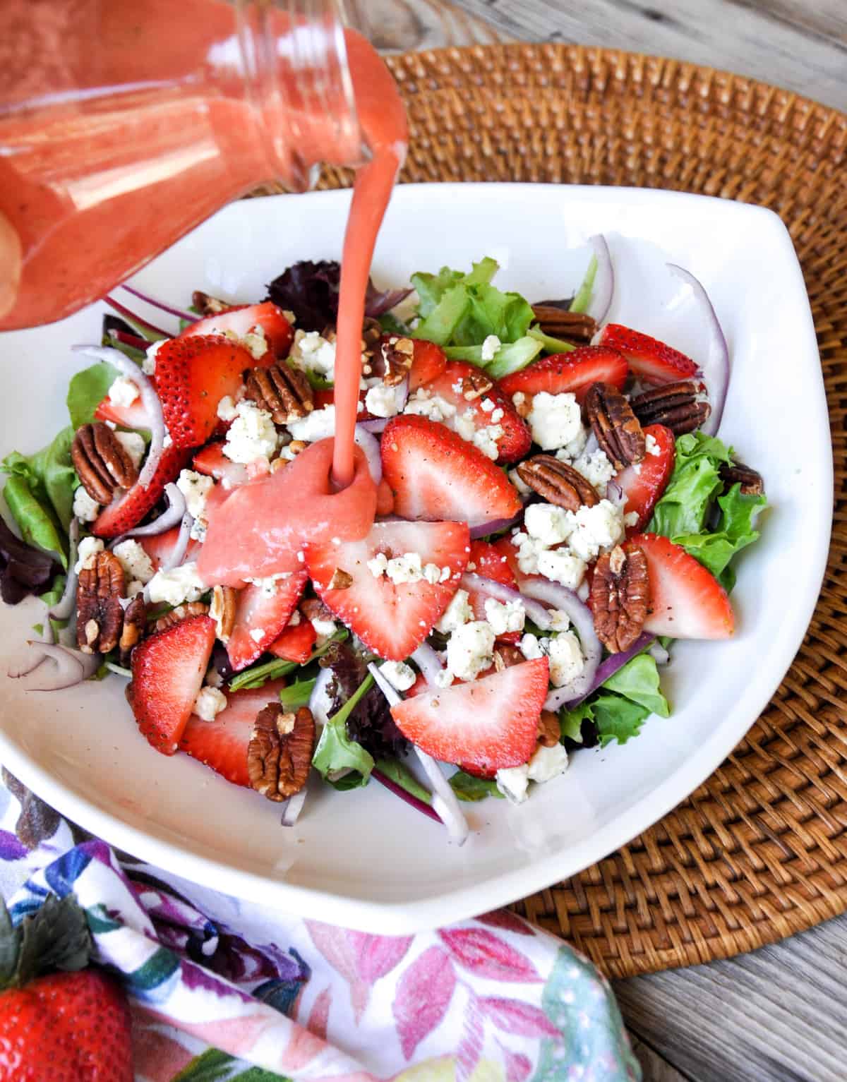 Pouring strawberry vinaigrette on Strawberry Salad