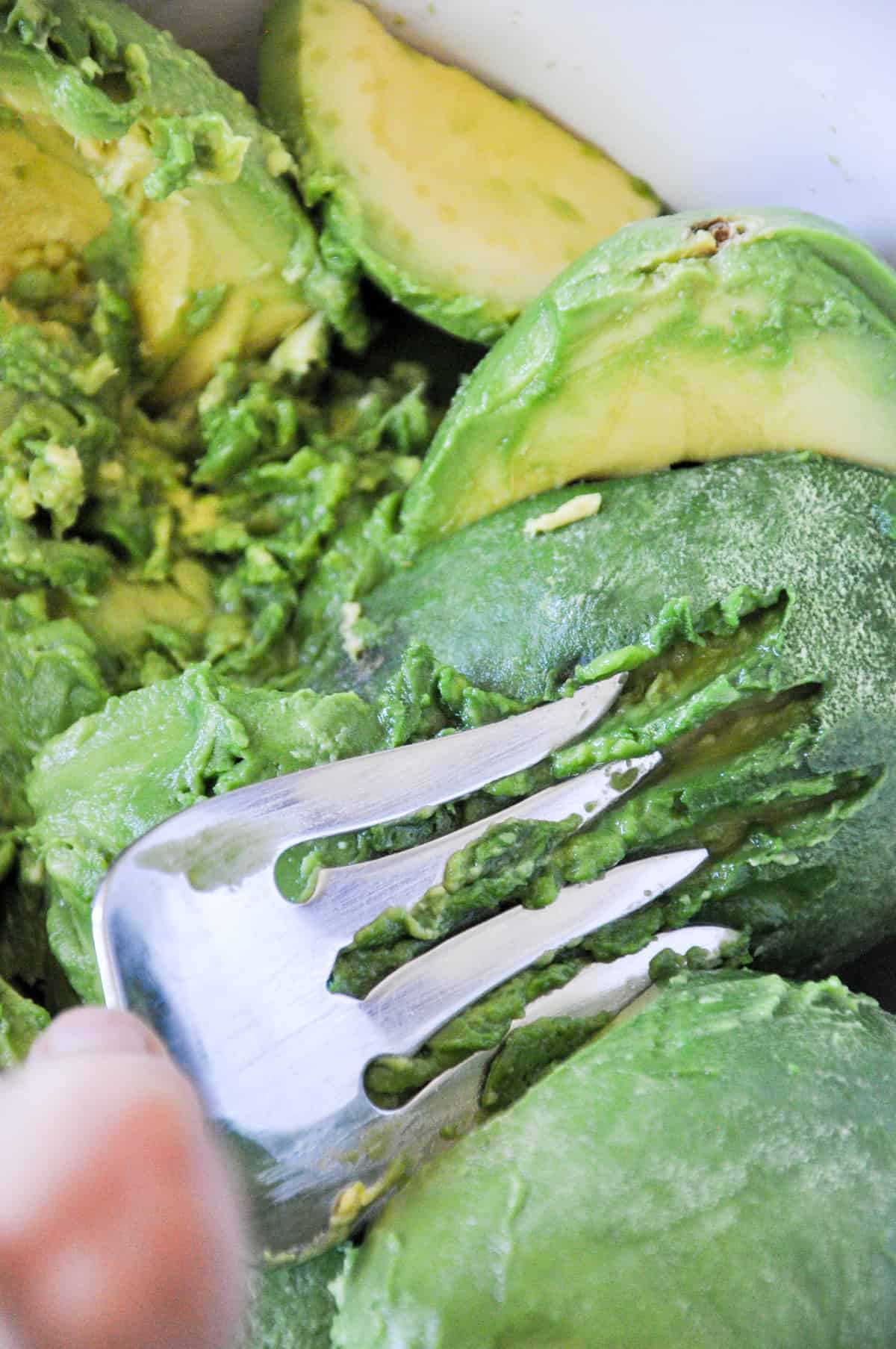 Mashing avocados with a fork