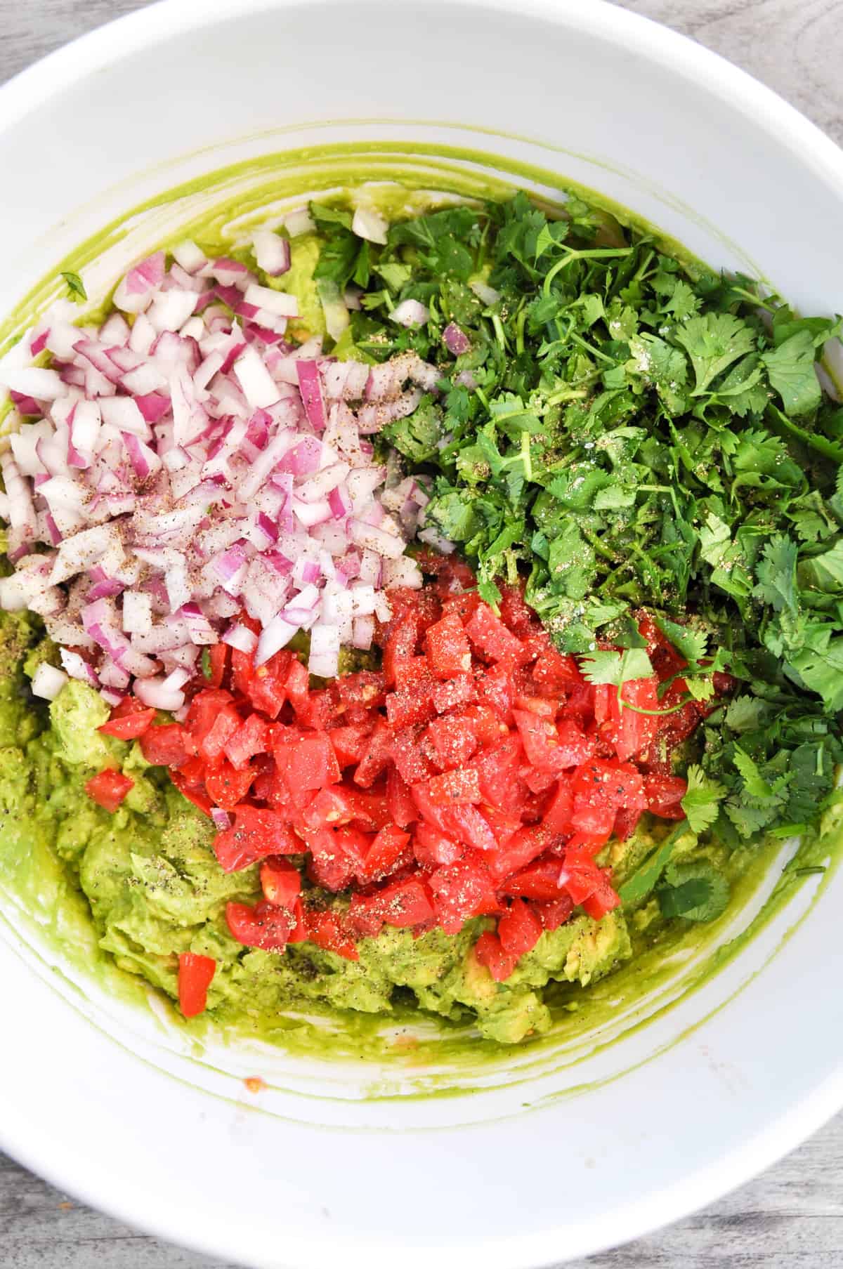 Diced vegetables, lemon juice, and salt and pepper added into a bowl