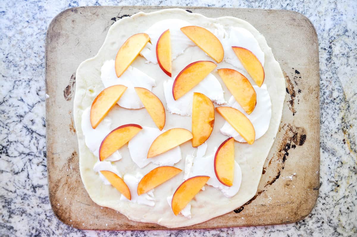 Thin slices of nectarines topped over the cheese