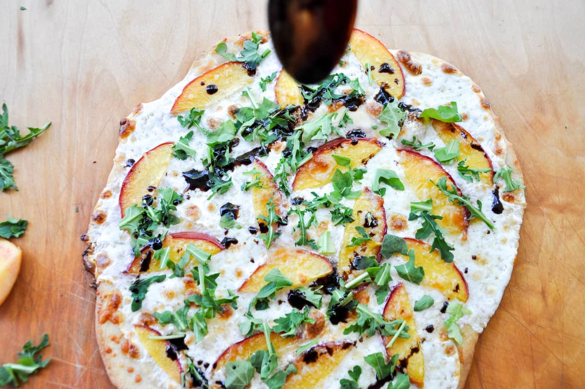 Finish topping the pizza with a balsamic reduction glaze