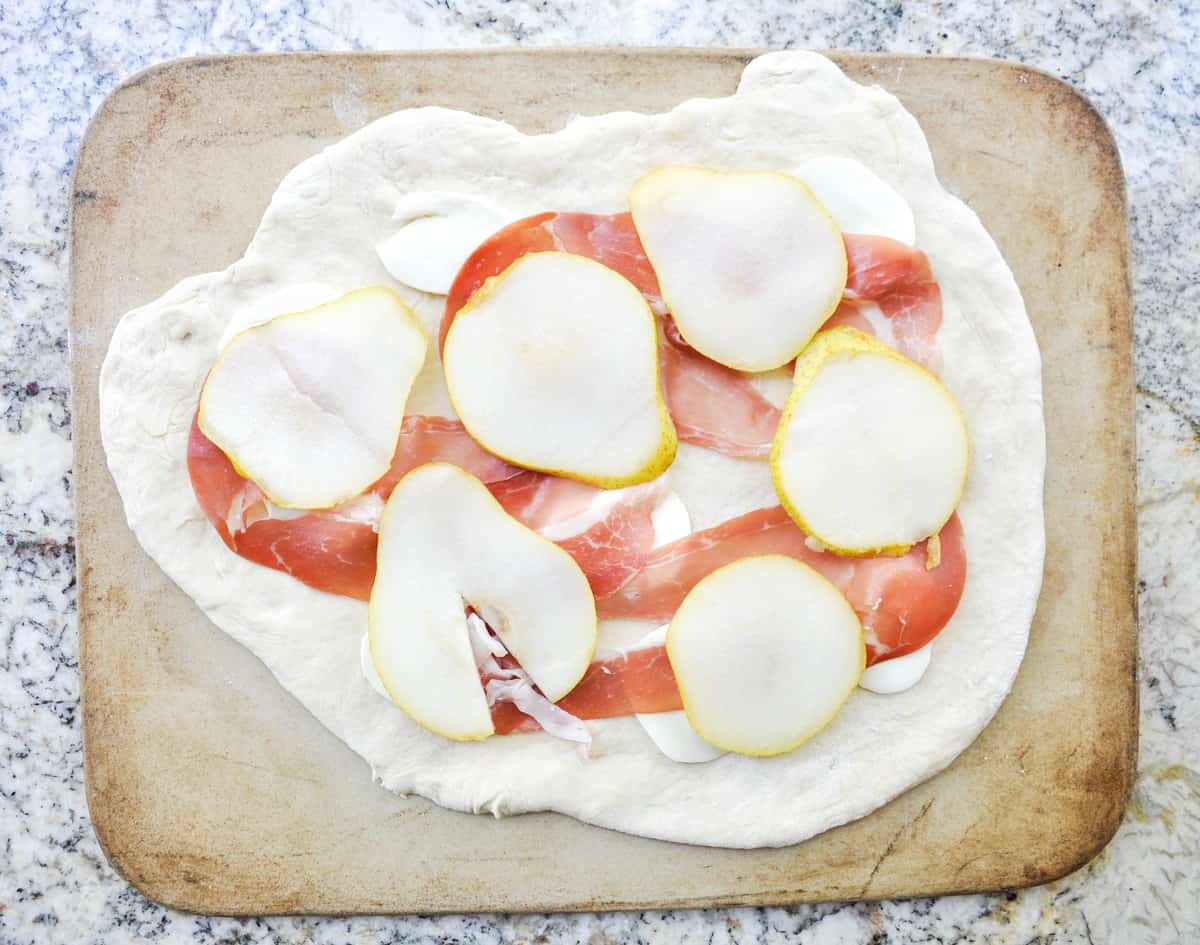 Pear & Prosciutto Pizza topped with red onion and gorgonzola. Yum-O-Licious!