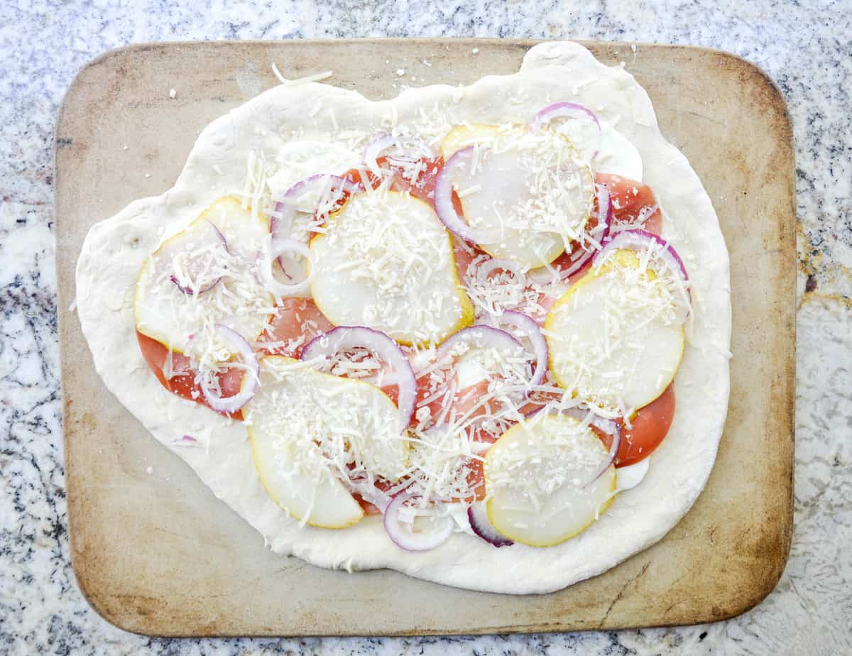 Pear & Prosciutto Pizza topped with red onion and gorgonzola. Yum-O-Licious!