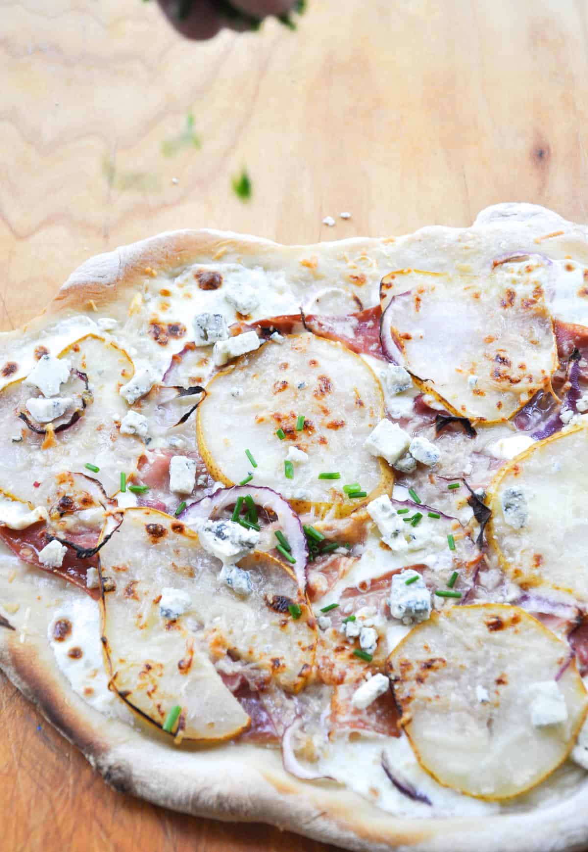 Pear & Prosciutto Pizza topped with red onion and gorgonzola. Yum-O-Licious!