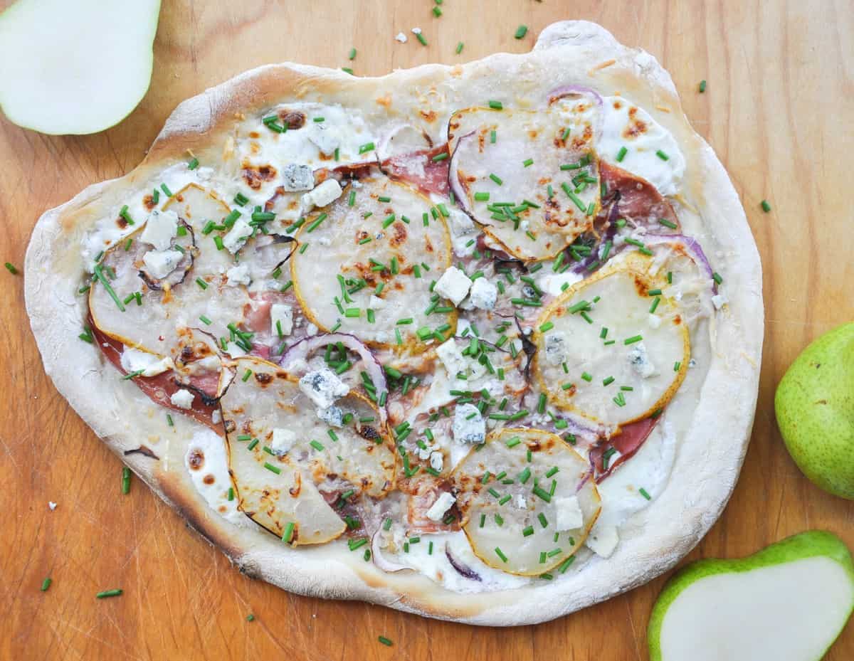 Pear & Prosciutto Pizza topped with red onion and gorgonzola. Yum-O-Licious!