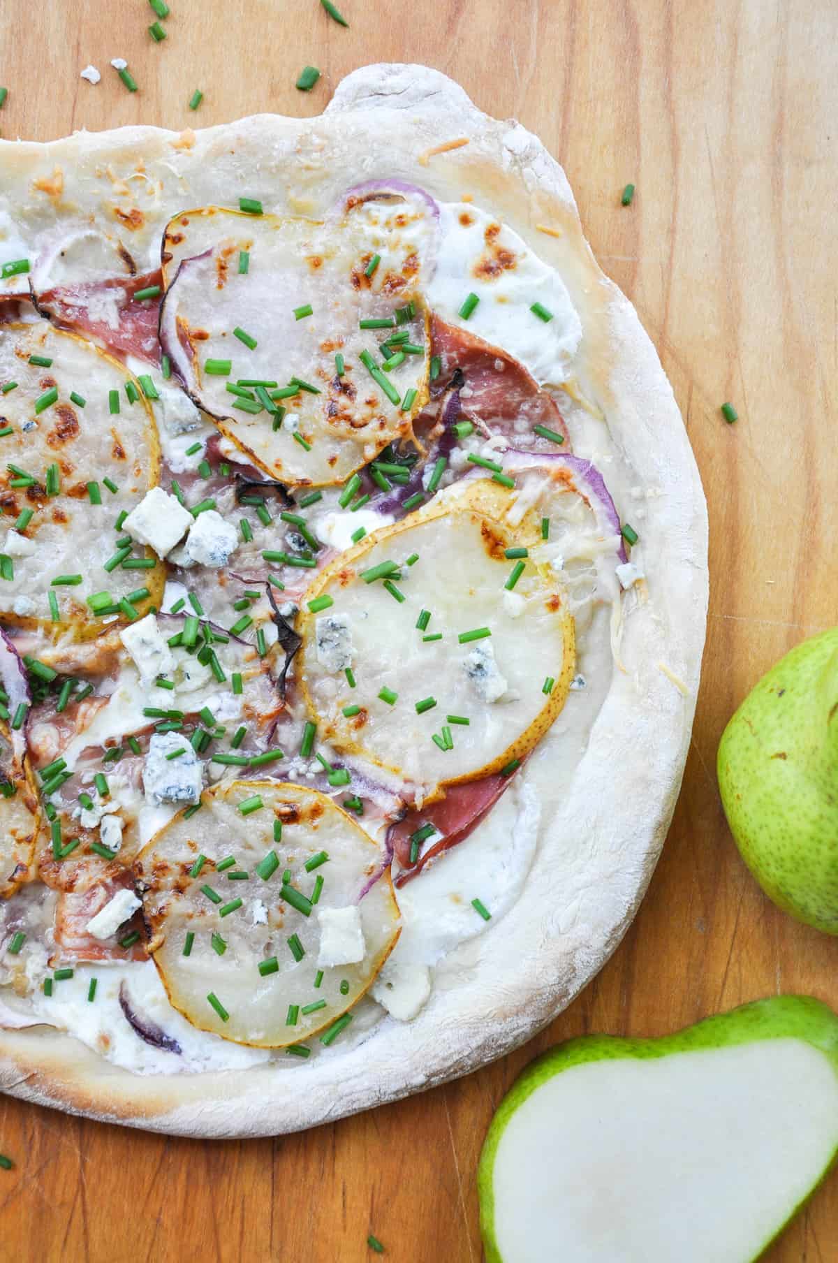 Pear & Prosciutto Pizza topped with red onion and gorgonzola. Yum-O-Licious!