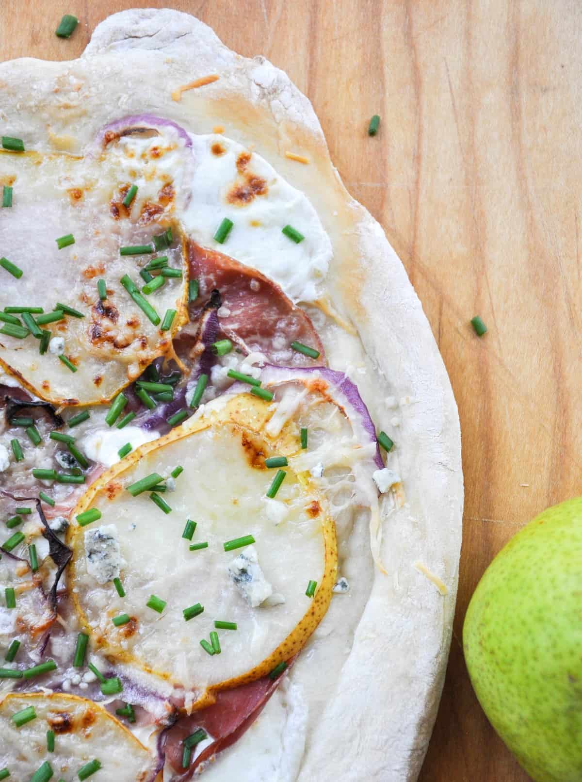 Pear & Prosciutto Pizza topped with red onion and gorgonzola. Yum-O-Licious!