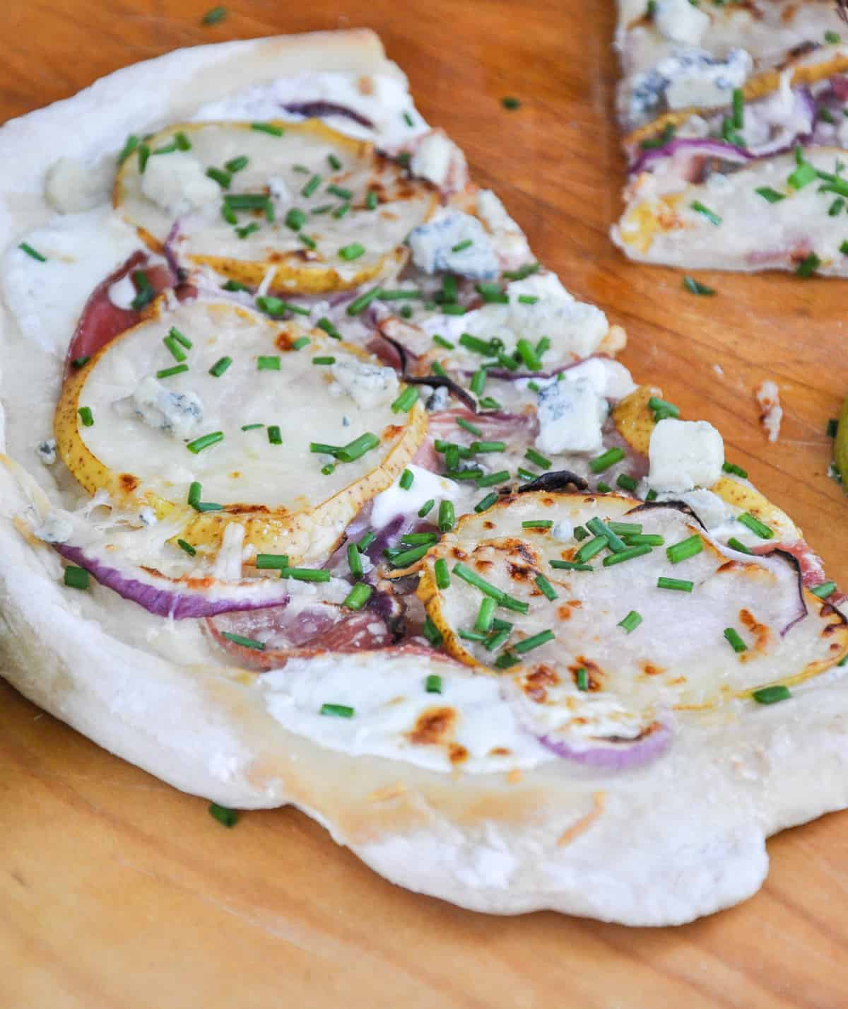 Pear & Prosciutto Pizza topped with red onion and gorgonzola. Yum-O-Licious!