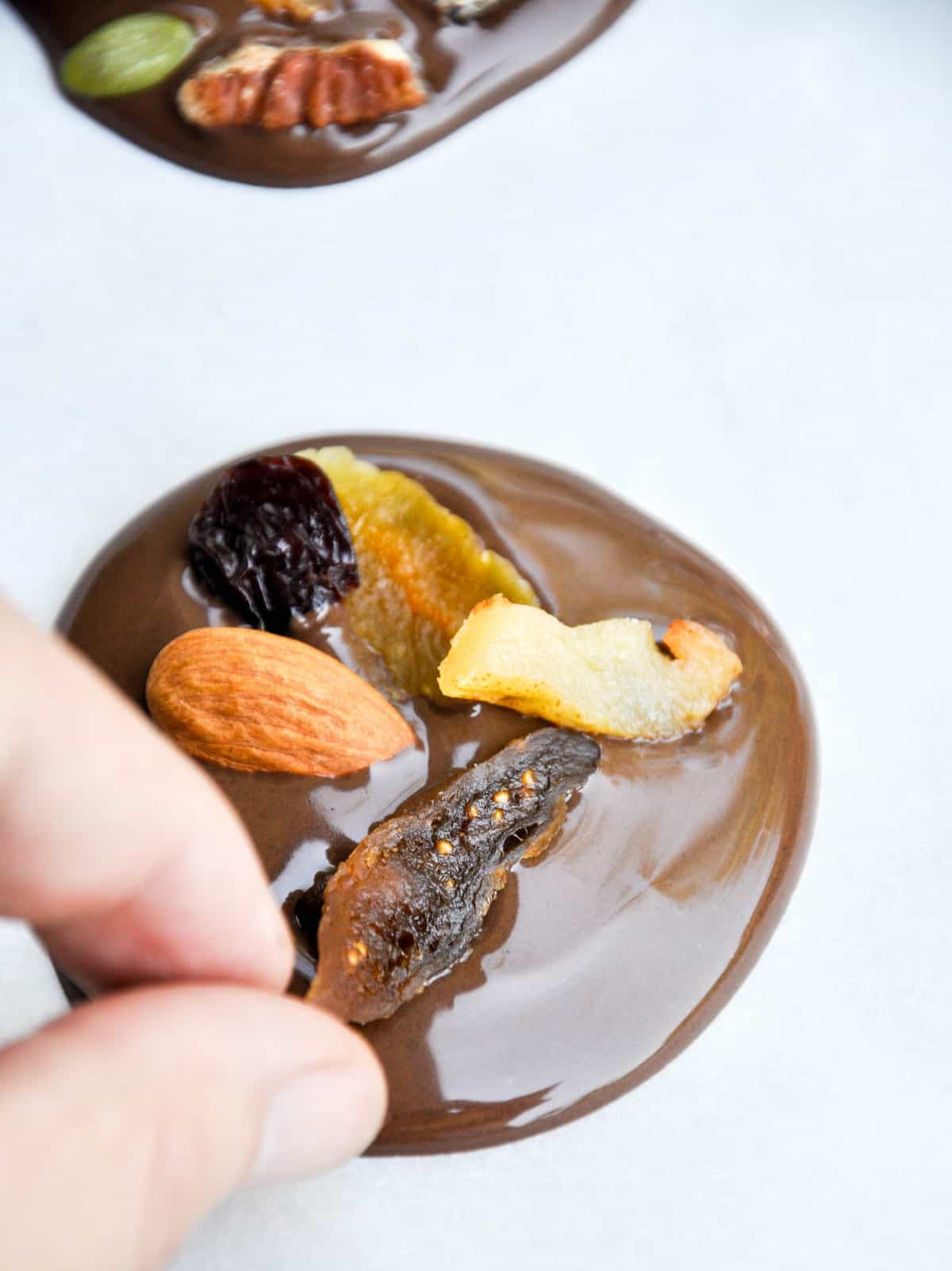 Adding dried fruit and nuts to chocolate rounds