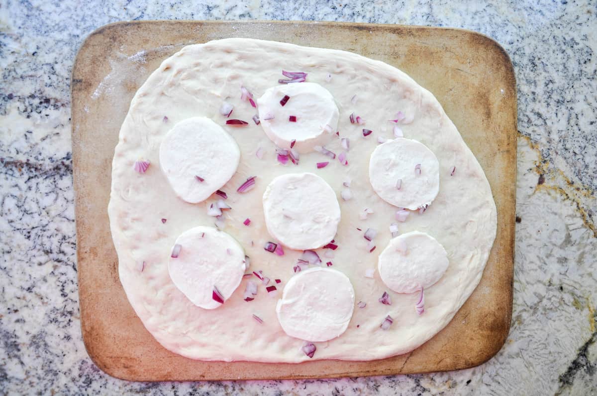 Red onion added to pizza