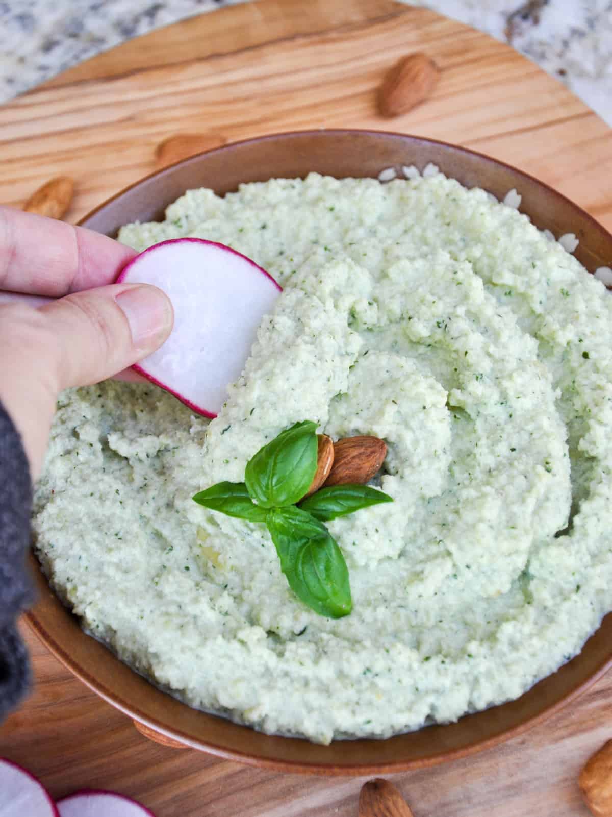 Dunking Radish Slice in Basil Almond Aioli