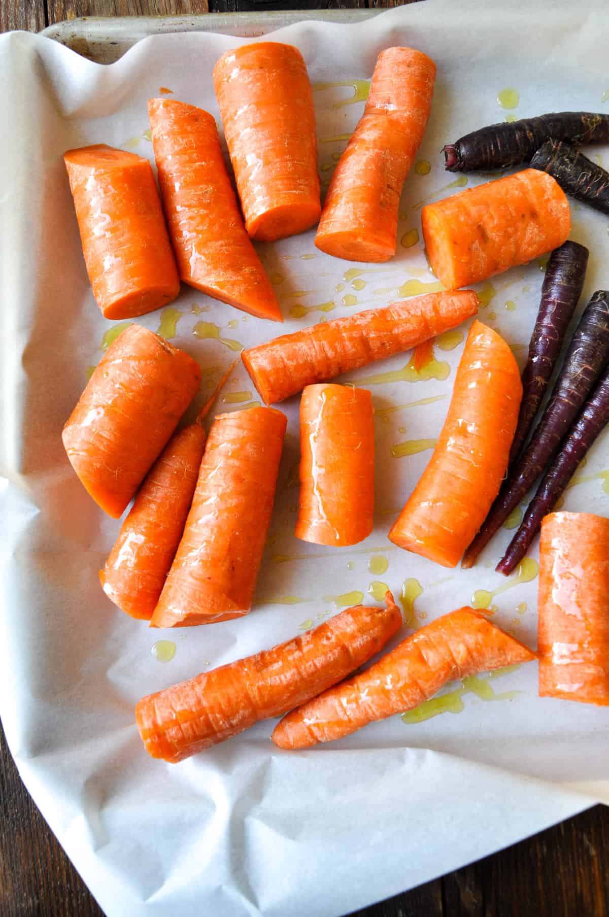 Halved carrots with olive oil drizzled over
