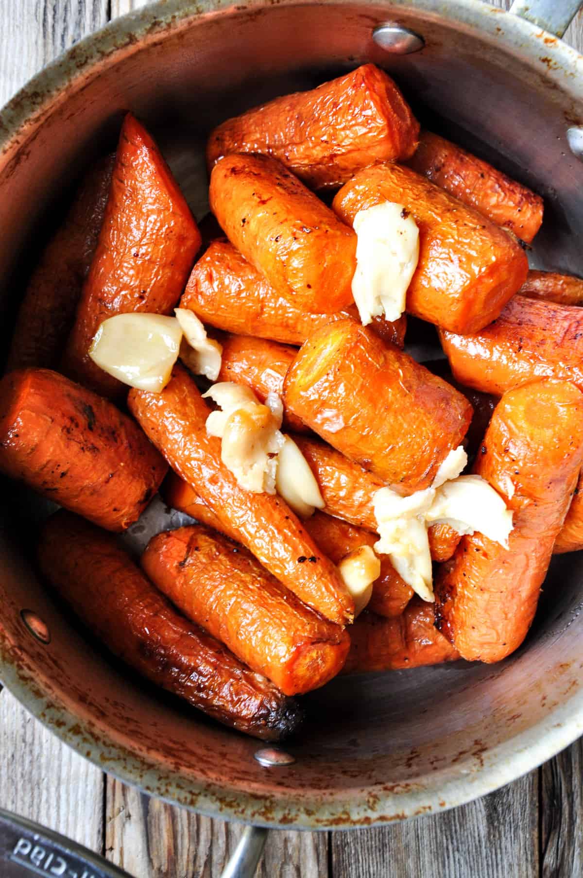 Roasted Carrots in a sauce pan with garlic