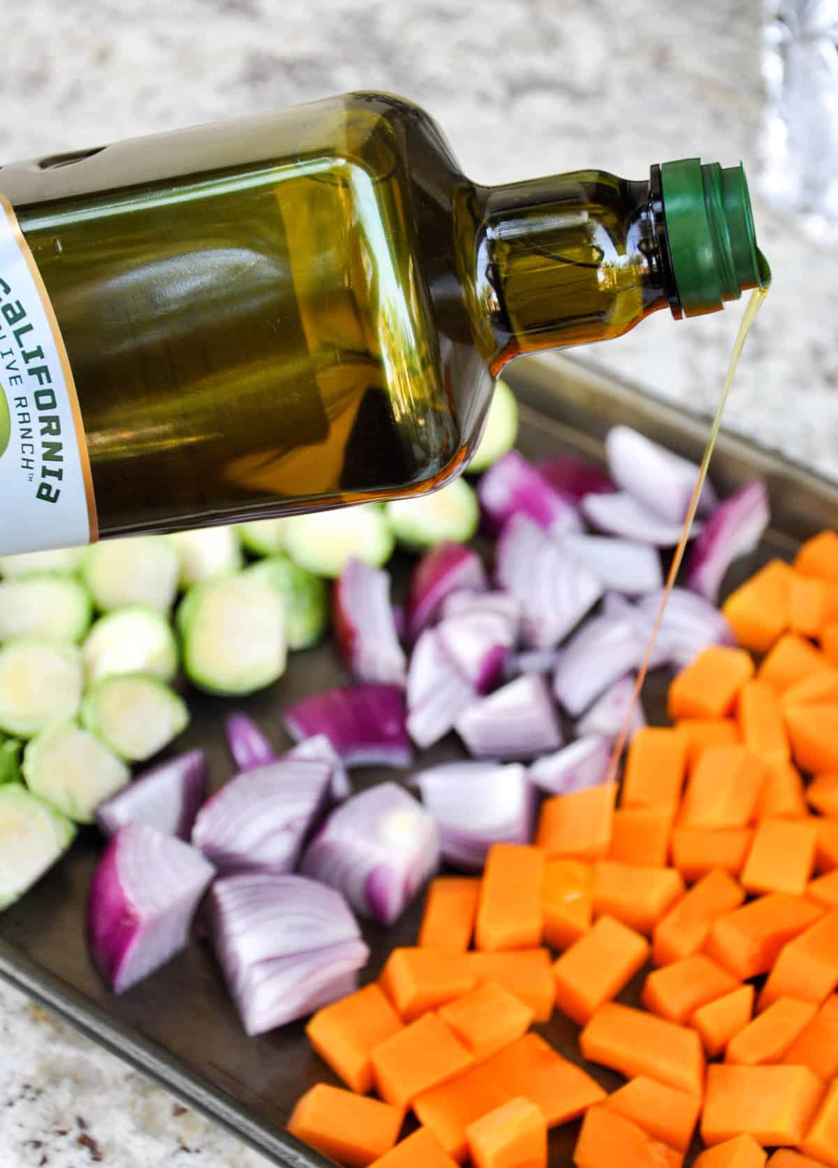 Drizzle olive oil over the vegetables 