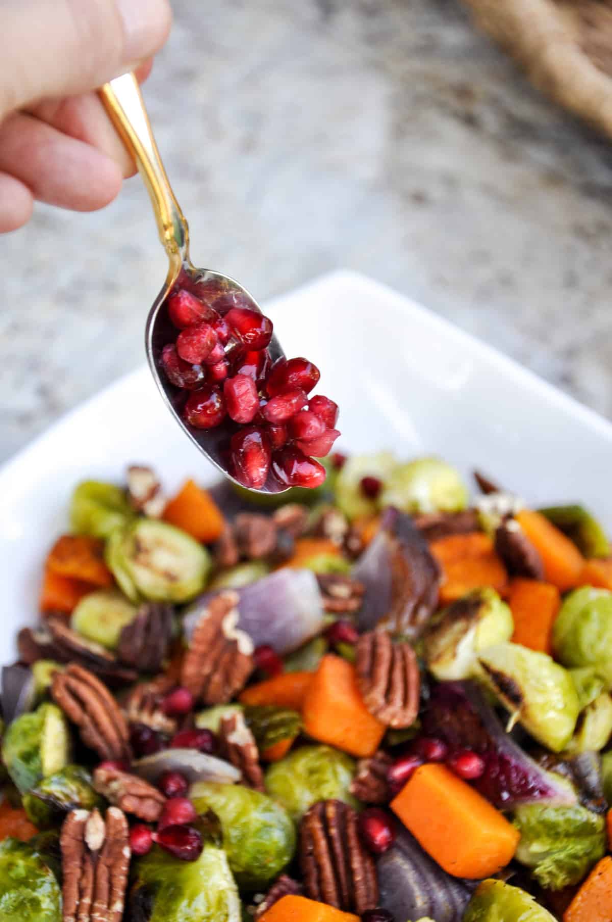 Add pomegranates to the roasted vegetables